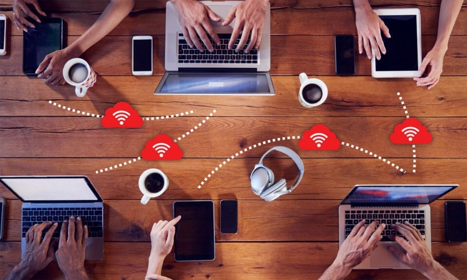 People working on laptops and phones on a shared WiFi network